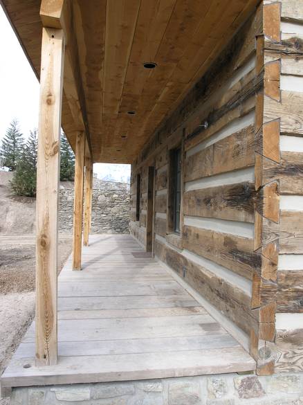 weathered timber siding porch / thick chinking and dovetailed corners