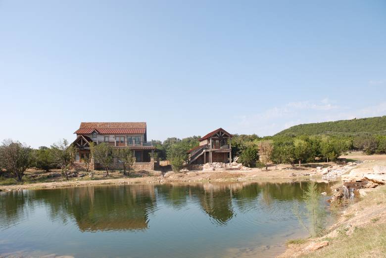 Residence and Garage/Guest Quarters viewed across the water