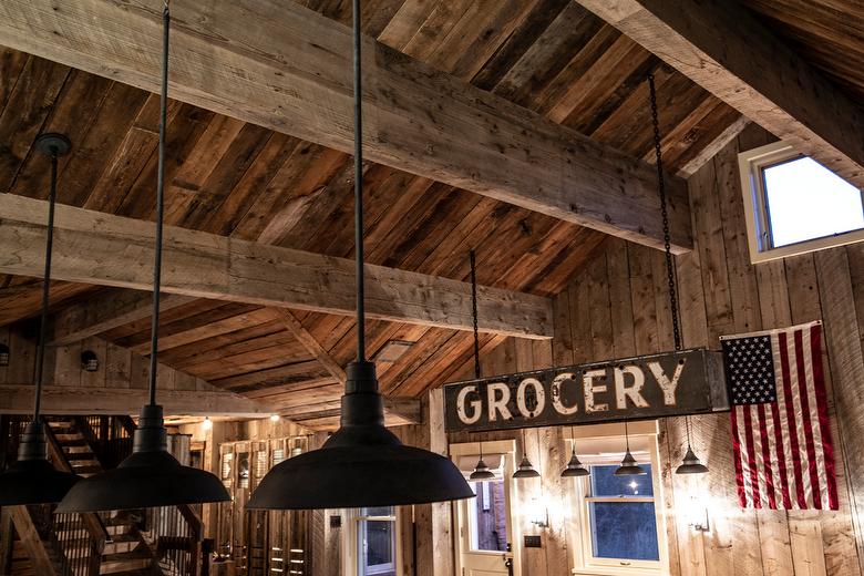 NatureAged beam wraps, paneling and cabinets. Antique Barnwood Gray/Brown ceiling, Trailblazer Skip-Planed flooring (60% Skipped), and Hand-Hewn Skins paneling (pressure washed)