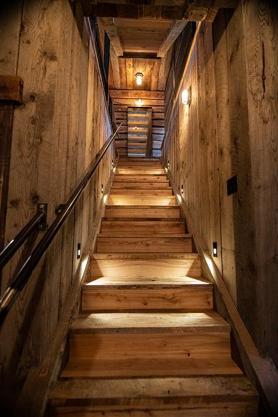 NatureAged beam wraps, paneling and cabinets. Antique Barnwood Gray/Brown ceiling, Trailblazer Skip-Planed flooring (60% Skipped), and Hand-Hewn Skins paneling (pressure washed)