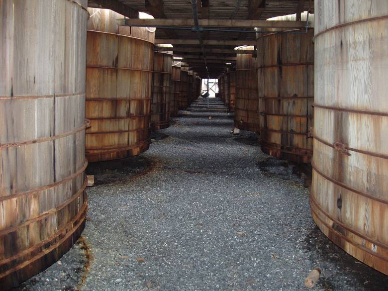 Pickle Tanks from Under the Walkway / These are wooden pickle vats in a pickle processing plant