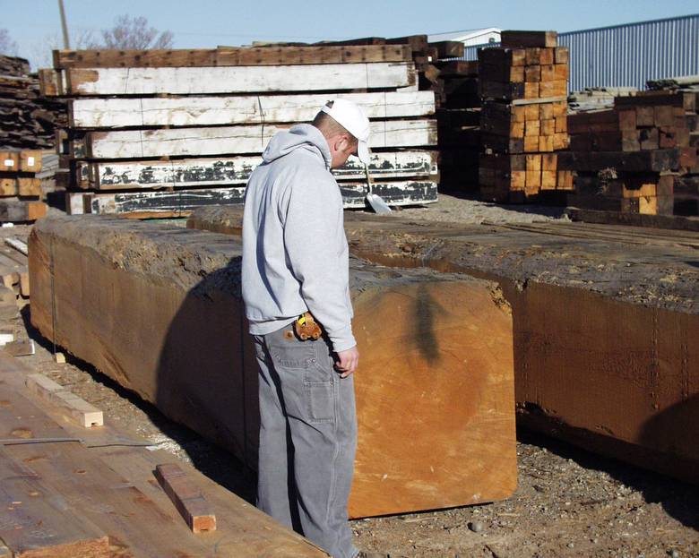 Large DF timbers / 5'10 worker helping show size of timbers