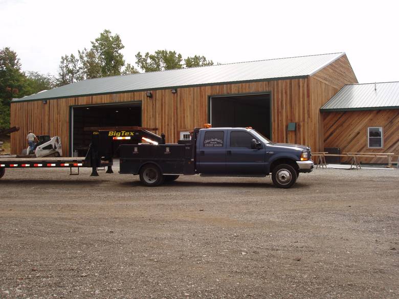 North side of Warehouse and Office / Note skidsteer in back and truck and trailer in front