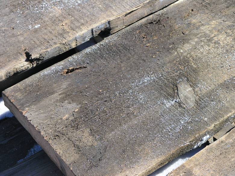 2x13 brown barnwood / Oil spot shown (The white on the lumber is snow.)