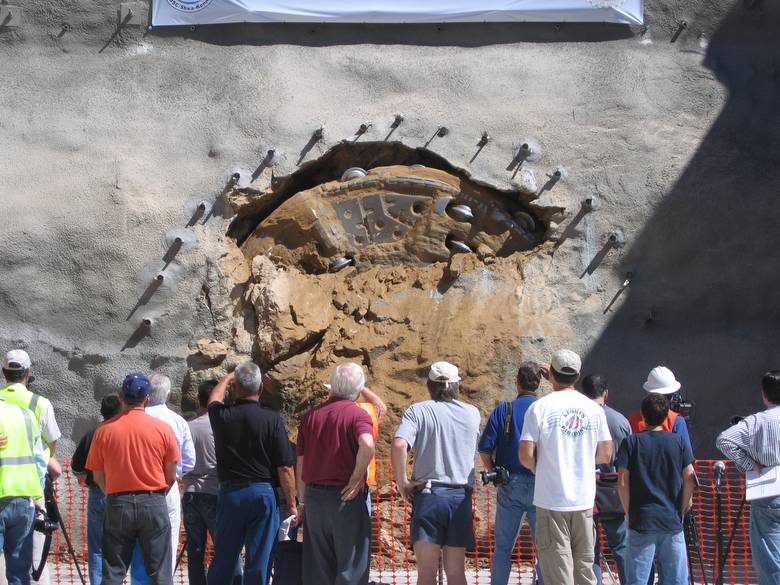 Tunnel Boring Machine breaking through a mountain face to finish Arrowhead Tunnel Project